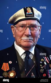 World War II veteran Ernie Lamson, 95, poses with a combat medic reenactor  before the Kenneth Moore and Robert Wright memorial ceremony, June 3, 2017,  in Angoville-au-Plain, France. This ceremony commemorates the