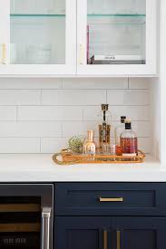 White And Blue Kitchen Features Navy Blue Shaker Cabinets Adorned Aged Brass Pulls Kitchen Tiles Backsplash Subway Tile Backsplash Kitchen Glass Cabinet Doors