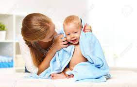 Be sure to test the water. Happy Family Mother And Baby In A Blue Towel After Bathing In The Bath Stock Photo Picture And Royalty Free Image Image 64792502