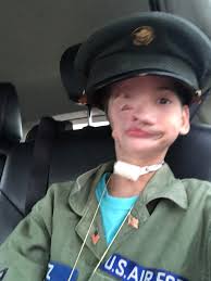 Gage wearing my dads old air force uniform and sunglasses