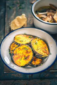Bengali Begun Bhaja Is A Dish Prepared Out Of Thick Slices Of The Eggplant Marinated In Spices And Coated With Rice Food Recipes Eggplant Dishes Baigan Recipes
