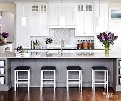 This beautiful contemporary gray and white kitchen offers a large open plan layout with an island big enough to seat three eat in diners. These White Kitchens Are Anything But Boring White Kitchen Design Kitchen Design Home Kitchens