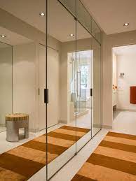 Using a wall of mirrors, it plays on the design element of pattern, which adds another level of interest to the room and complements the repeating pattern on the floor and cabinet. Home Mirrored Wardrobe Doors Modern Closet Designs Closet Designs
