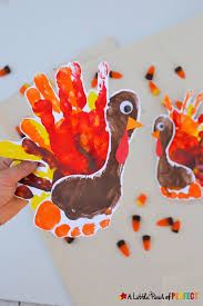 Foam balls, googly eyes, paint and colorful paper straws are all you need to help kids craft these cute turkey decorations for thanksgiving. Handprint And Footprint Turkey An Adorable Thanksgiving Craft For Kids