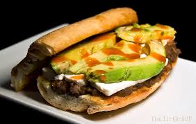 Top bottom buns with meat followed by tomatoes, red onions, iceberg, cotija, pickled jalapenos, and hot sauce. Mexican Tortas With Chorizo And Black Beans The Little Gsp