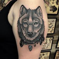 Awesome grey ink wolf head and dreamcatcher tattoo on shoulder. 1001 Ideas For A Beautiful Neo Traditional Tattoo