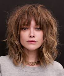 The trendiest medium length hairstyle with bangs is the layered lob with soft shaggy bangs because it suits everyone and can be styled in various ways. 25 Latest Medium Length Hairstyles With Bangs For 2021