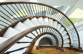 Wrought iron railing may be installed on treads, knee walls, or along flat surfaces, like balconies. China Modern Curved Staircase With Wrought Iron Railing Oak Wood Tread China Staircase Curved Staircase