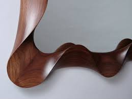 Go with a modern wall mirror framed with bone, wood or horn instead. Carved Walnut Mirror David Hurwitz Originals Randolph Vermont