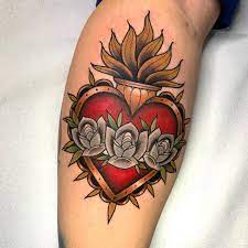 Heavenly clouds complete the religious symbolism in the design. Sacred Heart Tattoos All Things Tattoo