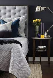 Master Bedroom Detail Dark Blue Wall King Size Bed With A Grey Tufted Wool Headboard In A Dark Blue Bedroom Walls Dark Blue Bedroom Walls Home Decor Bedroom