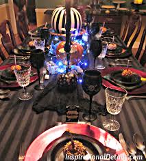 A chandelier is draped in wispy greenery, the table is set in rich rose gold details, and a haunted grand piano is brimming with balloons. Halloween Dinner Party A Spooky Gourmet Group Affair Inspirational Details