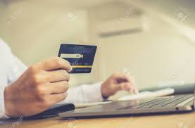 Credit cards charge a wide. Online Shopping A Young Man Holds A Credit Card To Make Payments Stock Photo Picture And Royalty Free Image Image 143047341