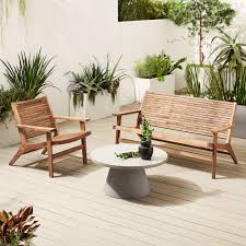 Outdoor seating made of teak consists of 4 chairs and a table. Acadia Outdoor Sofa Lounge Chair Pedestal Coffee Table Set