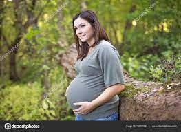 Beautiful pregnant woman relaxing on a park Stock Photo by ©Lopolo 166979994