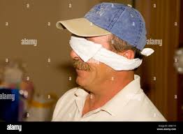 Blindfolded Man at a Party Stock Photo - Alamy