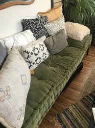 The back of the sofa supports an array of soft and cozy cushions. Rohini Velvet Daybed Cushion Urban Outfitters Daybed Cushion Green Sofa Floor Cushion Couch