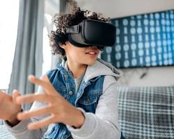 Image of child wearing a VR headset and playing a game