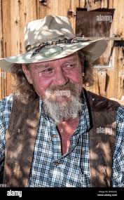 Old Cowboy in Wild West Town of Oatman,Arizona,USA,America,on the history  Route 66 famous for gunfights roaming Donkeys Burro Stock Photo
