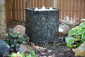 A fountain pump provides water to this statue. Stacked Slate Spillway Wall 32 Landscape Fountain Kit Aquascape Inc