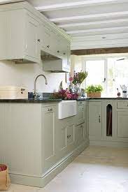 This transitional style gourmet kitchen matches old and new elements, with the use of classic paneling profiles for the white kitchen cabinets, glass framed display cabinets and dark wood laminate for the kitchen island casework. Image Result For Green Kitchen Cabinets Marble Worktop Green Kitchen Cabinets Green Kitchen Countertops Kitchen Remodel