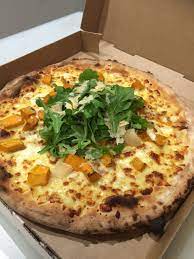zucca pizza with roasted pumpkin goat cheese pine nuts and rocket sprinkled with extra virgin olive oil on a mozzarella base dine winter food pumpkin recipes