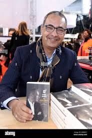 Kamel Daoud signs his book at The Book Fair in Paris, France