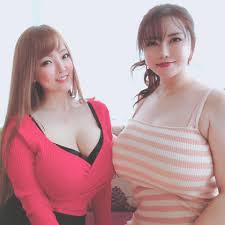 okita anri, tanaka hitomi, real life, highres, photo (medium), tagme,  2girls, breast touching, breasts, brown hair, cleavage, closed mouth, huge  breasts, japanese (nationality), large breasts, lipstick, long hair,  looking at viewer, makeup,