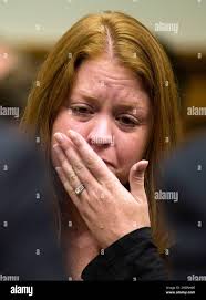 Sara Stone sits behind her husband, Stephen Stone, a Transocean, Ltd.  employee and survivor of Deepwater Horizon explosion, as he testifies