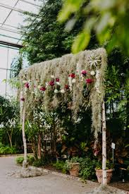 Hanging Air Plants Spanish Moss And Lush Blooms Create A Stunning Backdrop For Your Nuptials And Photos Flora Moss Wedding Spanish Moss Wedding Wedding Hoop