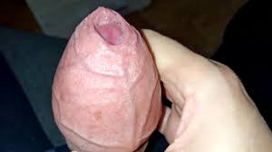 A big head of a large uncircumcised penis, smegma lubrication and a lot of  sperm