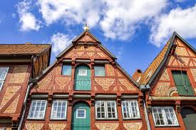A side gable signifies a pitched roof that contains two equal sections or sides that are slanted in an angular fashion. Germany Lower Saxony Lueneburg Old Town Gable Houses Historical Clouds Stock Photo 263850272