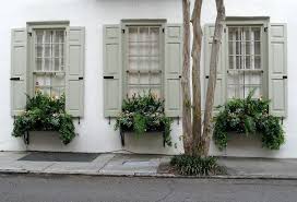 Not only will it instantly become more inviting and pleasing to the eye, but the property will also gain enduring window treatments capable of sheltering your glass surfaces from bad weather for many years to come. Window Boxes With Pale Green Shutters Tradd Street Charleston Sc Shutters Exterior Window Shutters Exterior Green Shutters