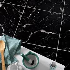 Using tiles, instead of whole slab of marble, is a more economical choice, and the chevron pattern used here is particularly striking. Marquina Black Gloss Marble Effect Tiles Walls And Floors