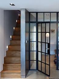 Internal Steel Framed Windows And Doors Act As A Transparent Screen Between The Living And Eating Spaces In The Basement Home Windows And Doors Stair Lighting