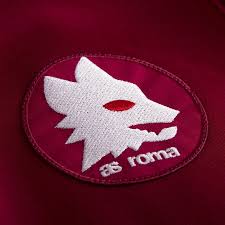 In quella superiore c'era la lupa su sfondo giallo, mentre in quella inferiore lo sfondo era rosso ed era presente l'acronimo asr in bianco. L As Roma Lancia La Collezione Maglie Storiche