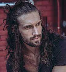 Sad frustrated man with long dark wavy hair and beard looking far away. 60 Awesome Long Hairstyles For Men 2021 Gallery Hairmanz