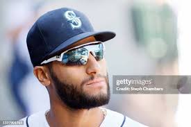 CEO John Stanton shakes hands with Abraham Toro of the Seattle... News  Photo