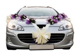 A Modern Silver Wedding Car Decorated With Wide White Ribbon And Purple Themed Floral Corsages Timelesstreasure Car Decor Wedding Car Wedding Car Decorations