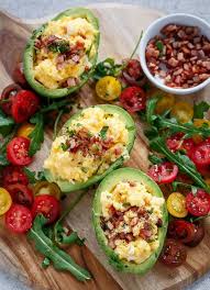 Cheesy Scrambled Eggs In Avocado With Bacon Pieces Recipe Avocado Recipes Food Healthy Snacks
