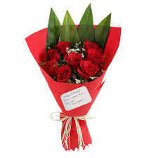 A bouquet of roses and daffodils is decorated with needles. The Floralmart Birthday Special Fresh Flower Bouquet Of 10 Red Roses In Paper Packing Amazon In Home Kitchen