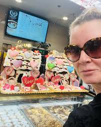 So smart. Look at these. The bakery in the grocery store took gingerbread  houses from Christmas and removed all of the Christmas trees and candies  and replace them with Valentines cookies and