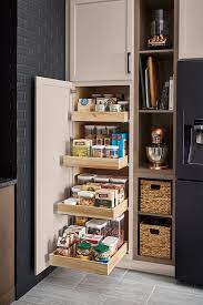 Free up pantry storage space by hanging measuring cups inside a kitchen cabinet. A Tall Pantry With Roll Trays Makes Achieving A Well Organized Kitchen A Breeze Click To Minimalist Small Kitchens Kitchen Cabinet Design Diy Kitchen Storage