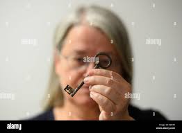 Legal Historian at The National Archives Dr Amanda Bevan holds two keys,  discovered in mail bags aboard ships seized by the Royal Navy between the  17th and 19th centuries, which forms part