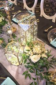 Geometric Figurines As Armatures For The Floral Designs And Geometric Glass Lanterns Www Country Wedding Decorations Wedding Centerpieces Wedding Decorations