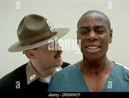 Drill instructor Monserrate Ponce demonstrates his use of military  discipline with Rikers Island inmate Benjamin Brooks, May 1992. Brooks is  at the Mateo Institute of Training at the New York City jail