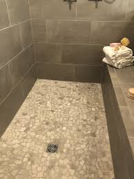 My shower is raised up on a platform, i believe due to the pipes underneath. Skybridge 12x24 Gray Wall Tile With Chennile White River Pebbles Shower Pan Shower Wall Tile Shower Tile White Tile Shower