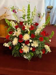 A church altar decorated with flowers on christmas day. Church Altar Flower Arrangement Church Flower Arrangements Altar Flowers Flower Decorations