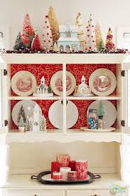 Someone gave me some brightly colored silk gerberas, with which i've decorated a china cabinet that she also gave us. Christmas China Cabinet Decorating