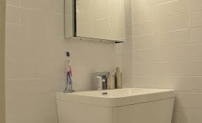 The custom oak vanity is topped in a simple white countertop. White Bathroom Design Philadelphia Simple Kitchen And Bath
